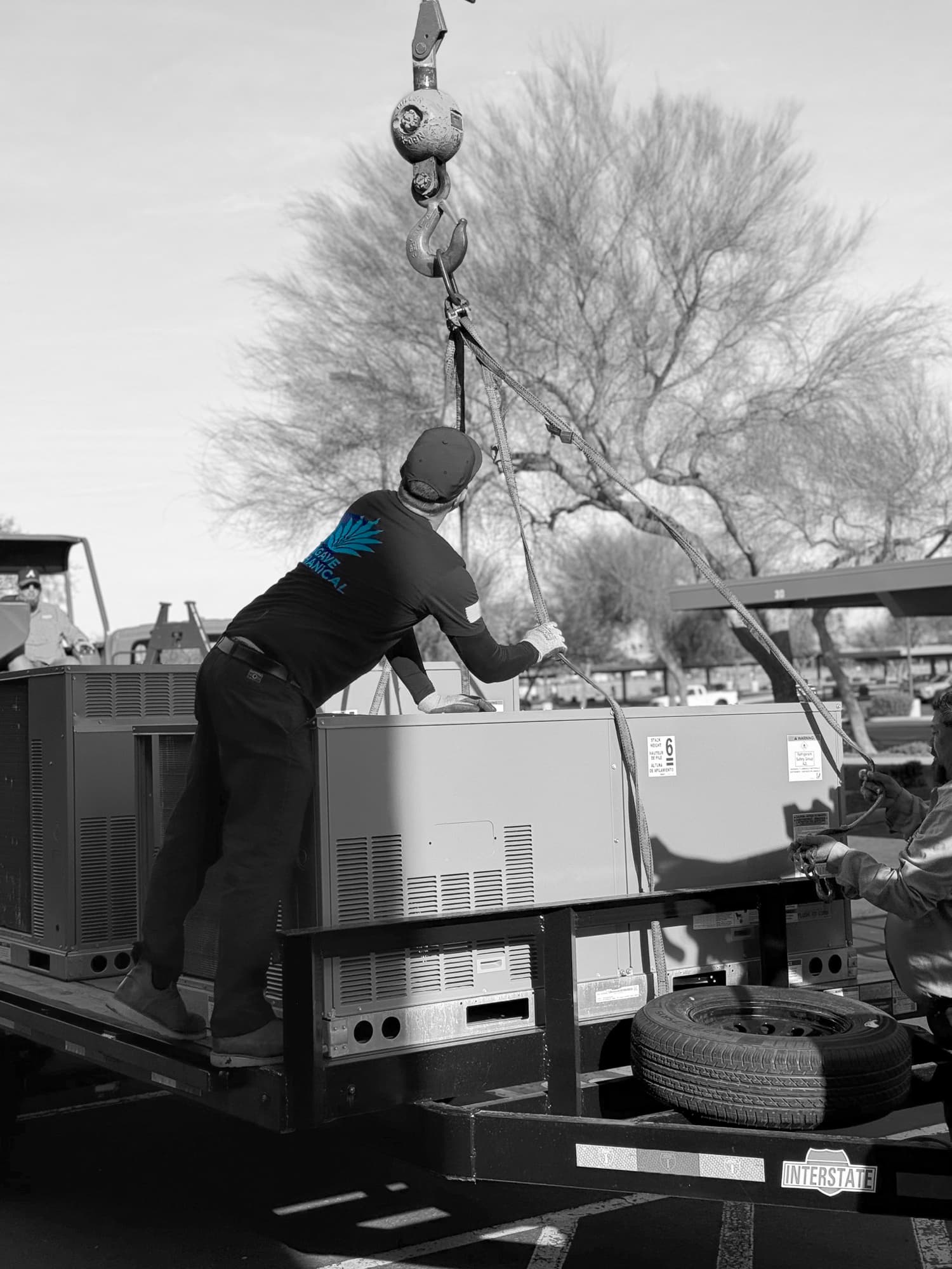 An Agave technician rigging a rooftop unit for a crane lift