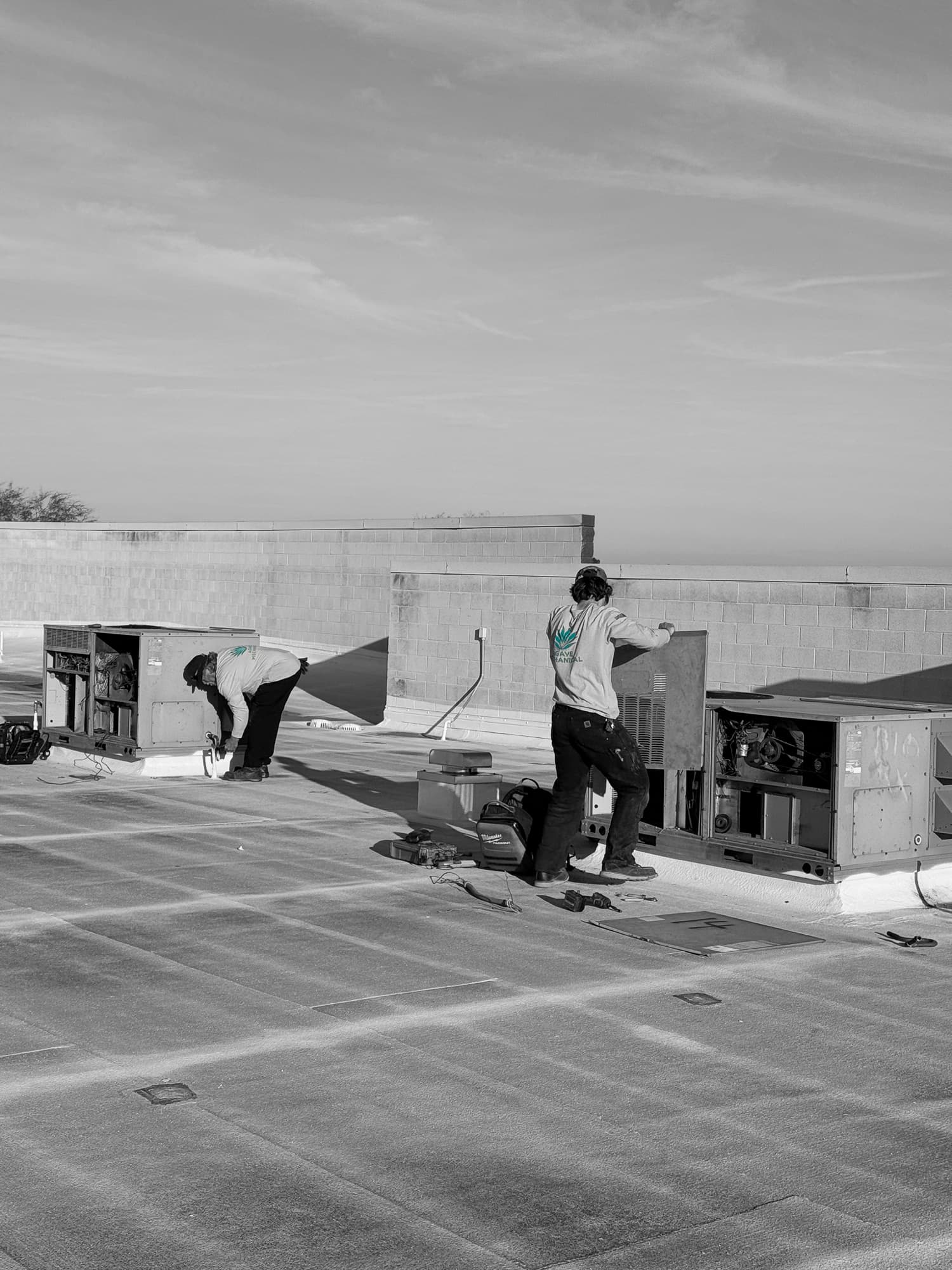 Two Agave technicians inspecting rooftop units
